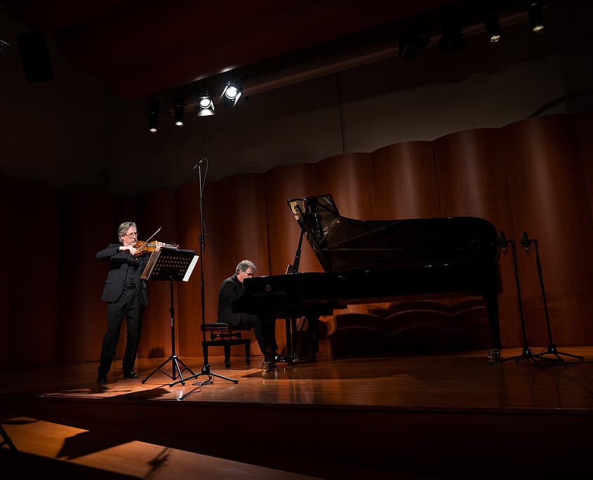 Un duo musicale con pianista e clarinettista durante un concerto sul palco di Le Salon Musical.