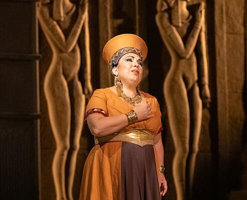 Vocalist in costume during a theatrical performance at Le Salon Musical.